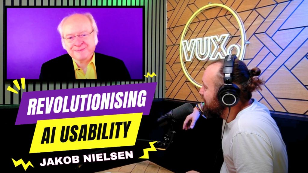 A podcast recording featuring a remote video interview with Jakob Nielsen, who appears on a screen with a purple background. He is an older man with white hair, glasses, and a black suit over a yellow shirt, smiling. On the right, a bearded man with a tied-back bun, wearing headphones and a white shirt, speaks into a microphone in a professional podcast studio with wooden paneling and a neon 'VUX' sign. The image includes bold text reading 'Revolutionising AI Usability' in purple and yellow, with Jakob Nielsen’s name highlighted below.